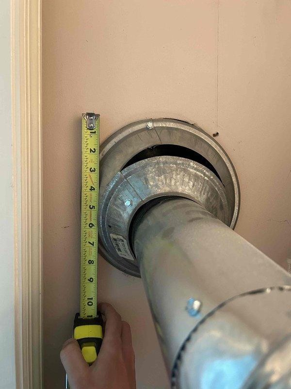 Responded to non-urgent service call regarding loose and improperly installed upper furnace flue pipe with inadequate drywall clearance identified during pre-sale home inspection. Upon arrival, assessed the B-vent or metal flue pipe penetration through the wall assembly and confirmed insufficient clearance between the vent pipe and combustible drywall materials, creating a code violation and potential safety hazard. Measured existing clearances and documented deficiencies with the wall thimble installation. Corrected the flue pipe positioning by properly seating the vent pipe into the wall-mounted metal flange assembly, ensuring the pipe was fully engaged and secured within the thimble. Verified proper clearances were maintained between the vent pipe and all combustible materials per manufacturer specifications and local building codes. Confirmed the flue pipe connection was stable and properly aligned for safe exhaust venting from the furnace system.