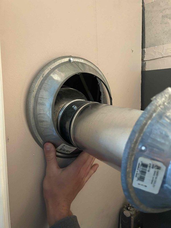 Responded to non-urgent service call regarding loose and improperly installed upper furnace flue pipe with inadequate drywall clearance identified during pre-sale home inspection. Upon arrival, assessed the B-vent or metal flue pipe penetration through the wall assembly and confirmed insufficient clearance between the vent pipe and combustible drywall materials, creating a code violation and potential safety hazard. Measured existing clearances and documented deficiencies with the wall thimble installation. Corrected the flue pipe positioning by properly seating the vent pipe into the wall-mounted metal flange assembly, ensuring the pipe was fully engaged and secured within the thimble. Verified proper clearances were maintained between the vent pipe and all combustible materials per manufacturer specifications and local building codes. Confirmed the flue pipe connection was stable and properly aligned for safe exhaust venting from the furnace system.
