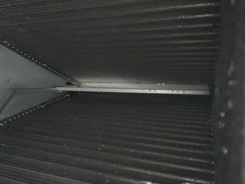Responded to no cooling complaint on a 4-year-old electric HVAC system with water leakage at the indoor unit. Upon inspection, found evidence of ongoing drainage issues with wet filter condition and water accumulation at the air handler located in the garage. Performed diagnostic evaluation of the evaporator coil assembly and examined the condensate drain system to identify the root cause of the cooling failure and water leakage that had persisted for three days.