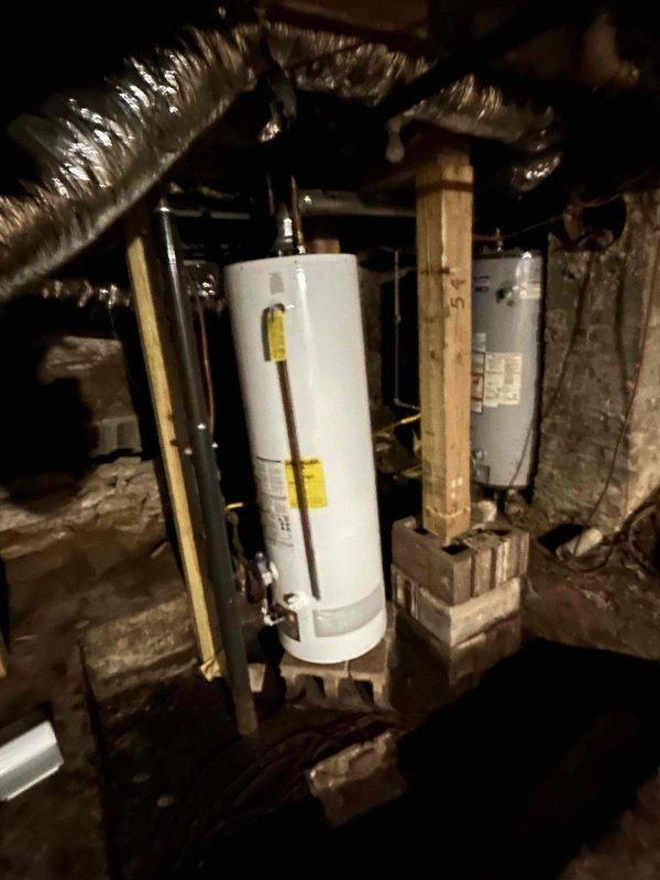 Responded to no hot water complaint at residential property. Upon inspection, diagnosed tanked water heater in basement with complete loss of hot water production. Assessed unit condition, verified electrical connections and plumbing infrastructure, and documented equipment setup including pressure relief valve, supply lines with color-coded insulation, and ventilation system. Photographed water heater installation and surrounding mechanical components for service records. Customer advised of findings and recommendations for restoration of hot water service.