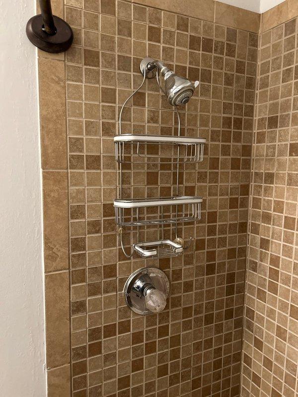 Completed plumbing inspection of condominium unit to assess bathroom fixture replacement requirements. Evaluated existing conditions of two toilets and two vanities across both bathrooms to provide accurate quote for removal and installation of new fixtures. Documented current plumbing configurations, water supply connections, drain lines, and surrounding tile work to determine scope of work and material specifications needed for replacement project.