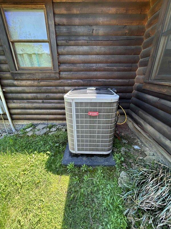 Completed comprehensive Care Plan maintenance on heat pump system with air handler located in basement. Performed thorough inspection and tune-up of outdoor heat pump unit positioned at exterior log cabin wall, verifying proper operation of condenser, refrigerant lines, and electrical connections. Serviced washable filter at indoor air handler unit in basement crawl space, ensuring optimal airflow and system efficiency for continued reliable heating and cooling performance.