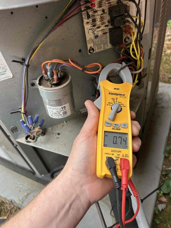Completed six-month routine maintenance on a four-year-old air conditioning system. Performed comprehensive AC tune-up including inspection of evaporator coils, which showed normal operational dust accumulation on fins, and electrical system diagnostics. Measured capacitor performance using clamp meter, recording readings within normal operating parameters. All components functioning properly with no repairs required.