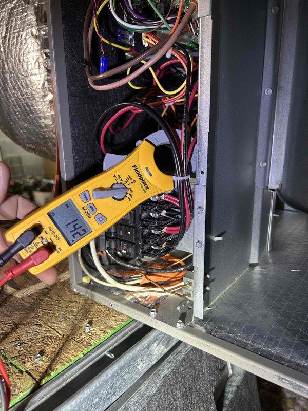 Completed comprehensive care plan tune-up on heat pump and air handler system located in walk-in crawlspace. Performed electrical diagnostics using digital multimeter and clamp meter, verifying voltage readings of 14.2V at control board and measuring current draw of 5.43A at contactor assembly. Inspected all electrical connections, terminal blocks, and wiring throughout control panel, confirming proper operation of contactors and circuit components. All system parameters tested within normal operating specifications.