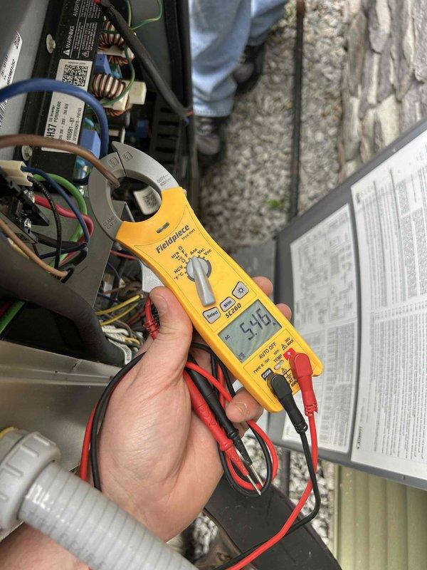 Completed comprehensive care plan tune-up on heat pump and air handler system located in walk-in crawlspace. Performed electrical diagnostics using digital multimeter and clamp meter, verifying voltage readings of 14.2V at control board and measuring current draw of 5.43A at contactor assembly. Inspected all electrical connections, terminal blocks, and wiring throughout control panel, confirming proper operation of contactors and circuit components. All system parameters tested within normal operating specifications.