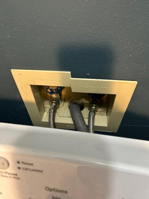 Provided comprehensive plumbing estimate for rental property conversion, evaluating and documenting shut-off valve replacement requirements throughout the home. Inspected and assessed washer/dryer hookup connections behind access panel, noting existing blue-handled valve and braided supply lines requiring replacement for improved reliability. Evaluated main water shut-off valve accessibility and condition near Lochinvar water heater in basement utility area. Photographed all plumbing components and connections to provide detailed documentation for repair scope and pricing approval.