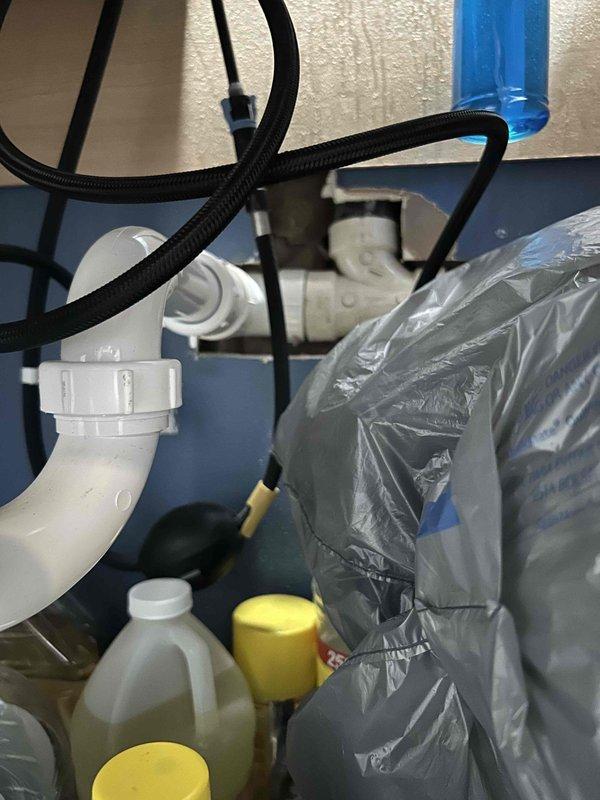 Responded to kitchen sink clog with water leaking onto floor. Upon arrival, accessed the cabinet base beneath sink and identified blockage in drain trap assembly. Removed and cleared obstruction from P-trap, inspected drain lines for proper flow, and verified all connections were secure to eliminate the leak source. Tested sink drainage with running water to confirm full functionality and proper water flow with no further leakage detected.