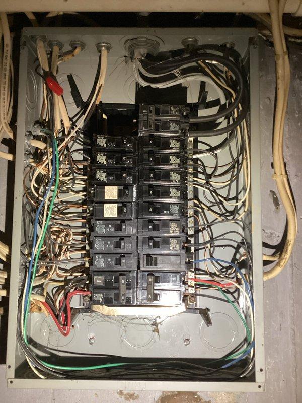 Conducted comprehensive site evaluation for backup generator installation at residential property. Documented existing electrical service entrance configuration, including weatherhead connection, exterior meter base with digital display, and main service panel location on exterior wall. Assessed interior main electrical panel capacity and current circuit breaker configuration to determine available amperage and compatibility for generator transfer switch integration. Photographed existing electrical infrastructure including service entrance conductors, meter socket mounting, panel bus configuration, and existing branch circuit wiring to develop accurate material and labor estimates for 10-12 kW standby generator system installation with automatic transfer switch.