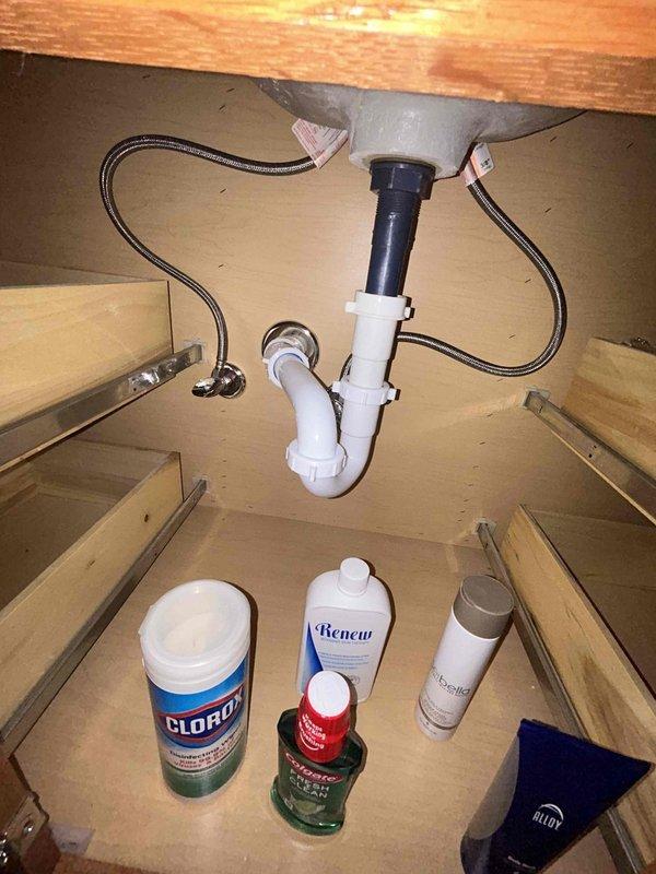Completed comprehensive 60-point visual plumbing inspection per GB protocol without flush testing. Inspected under-sink plumbing including P-trap configuration, PVC drain assembly, basket strainer mechanism, and braided flexible supply lines, confirming proper connections and absence of visible leaks. Evaluated shower fixture assembly including gooseneck pipe, rainfall showerhead operation, and control valve functionality, verifying adequate water flow and spray pattern with no observable drips or deterioration.