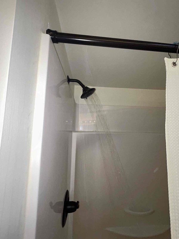 Completed comprehensive 60-point visual plumbing inspection per GB protocol without flush testing. Inspected under-sink plumbing including P-trap configuration, PVC drain assembly, basket strainer mechanism, and braided flexible supply lines, confirming proper connections and absence of visible leaks. Evaluated shower fixture assembly including gooseneck pipe, rainfall showerhead operation, and control valve functionality, verifying adequate water flow and spray pattern with no observable drips or deterioration.