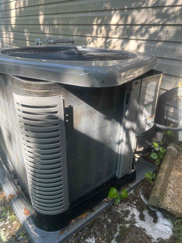 Completed routine preventative maintenance on a 3-year-old residential air conditioning system with outdoor condenser unit and attic-located air handler. Performed comprehensive AC tune-up including inspection of refrigerant lines, condensing coil, and all accessible components. Exterior of condenser unit showed significant dirt, grime, and debris accumulation requiring attention. Verified system operational status and documented equipment condition through photographic records. Customer provides their own air filters for the attic-mounted air handler and gas furnace system.