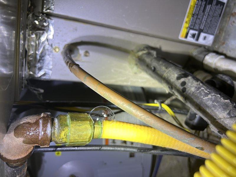 Detected small gas leak on copper fitting connected to yellow flexible gas line during HVAC service call. Upon investigation, determined the leaking line services the fireplace and will require replacement due to corrosion on the fitting and compromised connection integrity.