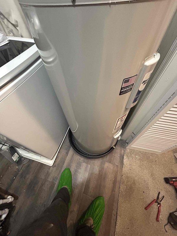Completed installation of a 40-gallon Bradford White electric water heater (short model, 22" x 47 3/16") in interior utility closet adjacent to laundry area. Removed and replaced existing water heater unit, positioned new tank on drain pan, and made all necessary electrical and plumbing connections to bring system into full operational status. Unit was staged from warehouse inventory and installed per manufacturer specifications with 6-year tank and parts warranty coverage.