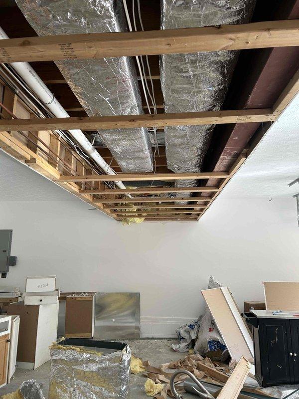 Completed full ductwork replacement in residential property due to water damage exposure throughout the existing system. Removed and replaced all galvanized metal supply ductwork with new galvanized metal trunk lines externally wrapped with R-4 foil-backed insulation. Installed new supply and return plenums connecting from HVAC equipment to main trunk lines, wrapped with R-4 foil-backed insulation. Replaced all flexible branch ductwork with new R-4 flex duct, including all supply takeoffs for each flex run. Reconnected all ductwork to existing floor boots and registers. Performed chemical cleaning of indoor evaporator coil and equipment cabinet interior to ensure optimal system performance. All work completed with drywall removal handled by others prior to ductwork installation.