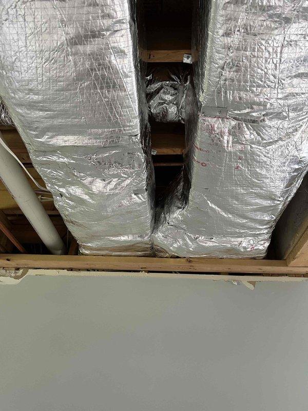 Completed full ductwork replacement in residential property due to water damage exposure throughout the existing system. Removed and replaced all galvanized metal supply ductwork with new galvanized metal trunk lines externally wrapped with R-4 foil-backed insulation. Installed new supply and return plenums connecting from HVAC equipment to main trunk lines, wrapped with R-4 foil-backed insulation. Replaced all flexible branch ductwork with new R-4 flex duct, including all supply takeoffs for each flex run. Reconnected all ductwork to existing floor boots and registers. Performed chemical cleaning of indoor evaporator coil and equipment cabinet interior to ensure optimal system performance. All work completed with drywall removal handled by others prior to ductwork installation.