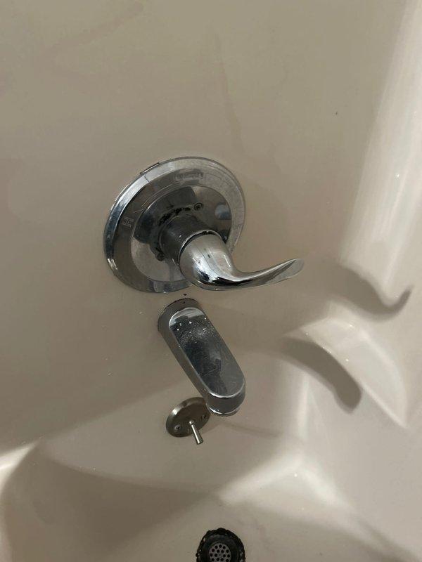 Responded to service call for leaking faucets in bathroom tub and kitchen sink. Inspected chrome bathtub faucet assembly and diverter valve for signs of wear and water damage, noting visible spotting on fixtures indicating active leak conditions. Evaluated under-sink plumbing connections at kitchen sink, examining garbage disposal unit, drainage lines, and flexible supply hoses for potential leak sources. Addressed leak issues at both locations to restore proper function and eliminate dripping.