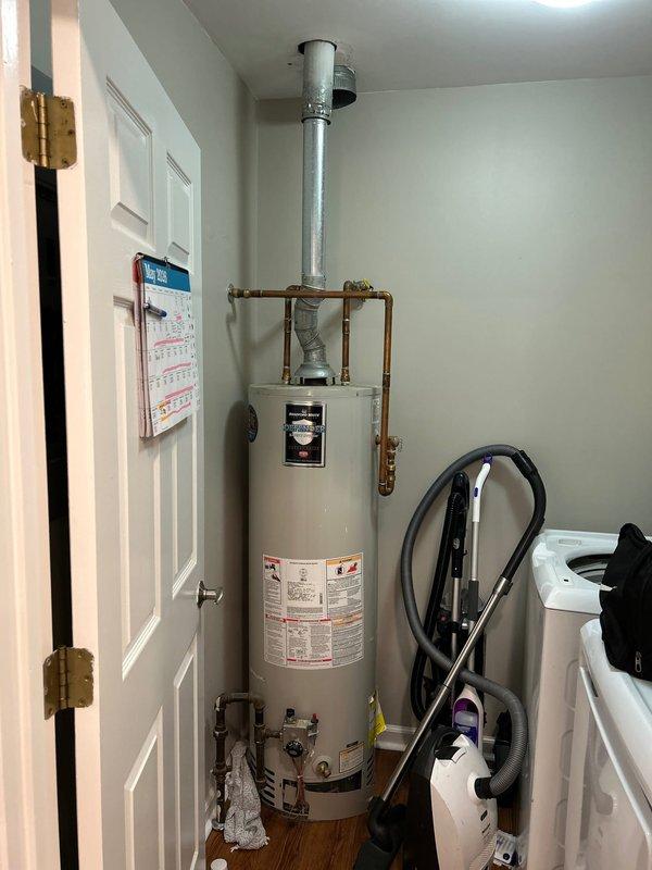 Responded to water leak above Bradford White water heater originating from vent system in laundry room utility closet. Upon inspection, identified active leak at vent pipe connection and draft diverter assembly above unit. Assessed copper supply lines, brass fittings, and galvanized venting system for source of moisture intrusion. Documented existing water heater installation including plumbing configuration, gas shut-off valve, pressure relief valve, and vent pipe routing. Provided assessment of current system condition and prepared replacement quote per customer request.