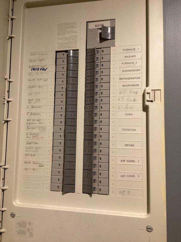 Conducted on-site electrical assessment for Kohler generator installation. Evaluated existing residential electrical panel configuration, documented current breaker layout and circuit distribution including HVAC systems, major appliances, and general branch circuits. Photographed panel interior showing three-column breaker arrangement with main disconnect and labeled circuits for furnaces, air conditioning units, kitchen appliances, and laundry equipment. Assessed available panel capacity and electrical infrastructure to determine requirements for generator transfer switch integration and load management system.