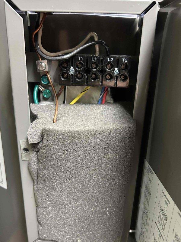 Removed existing 80-gallon electric water heater from basement utility area and installed new Rheem 80-gallon tanked water heater as replacement unit. Positioned new heater on elevated white metal platform stand to ensure proper clearance and accessibility for future maintenance. Connected unit to existing electrical supply, completing all wiring terminations at terminal block with proper color-coded conductors and secure connections within junction box enclosure.

Tied into existing hot and cold water supply lines using copper piping with soldered joints to ensure leak-free connections. Integrated new water heater with existing recirculation system, installing blue recirculation pump assembly on top of unit with appropriate copper pipe connections to maintain continuous hot water delivery throughout the building. Secured all horizontal supply lines to ceiling joists using proper pipe hangers and orange support straps to prevent sagging and ensure system longevity.

Completed all plumb