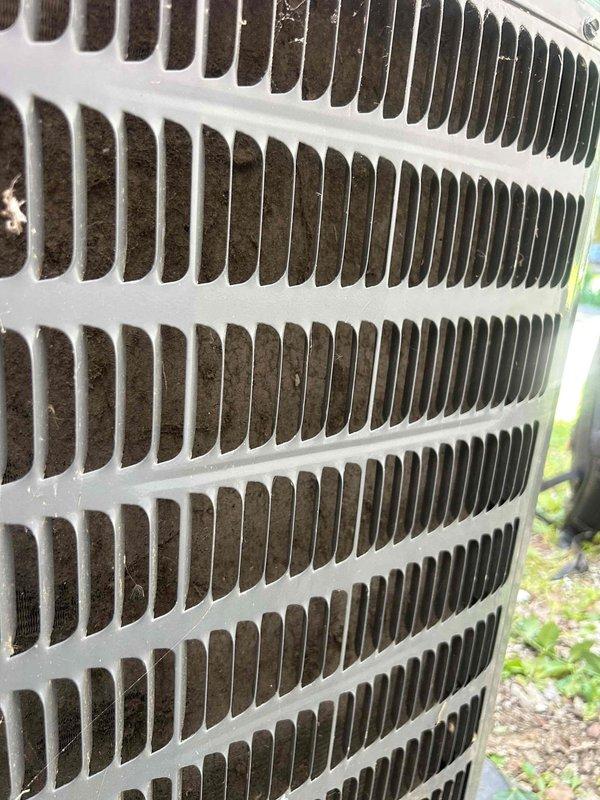 Completed comprehensive care plan tune-up on newly installed HVAC system consisting of two gas furnaces and one air conditioning unit with coil, all equipment located in attic. Performed diagnostic testing on outdoor condensing unit using clamp meter to verify proper electrical operation, measuring amperage draw at 0.56 amps. Inspected all equipment components, documented system conditions through photographs showing outdoor unit exterior with accumulated debris on protective grille, and confirmed all installations operating within normal parameters.