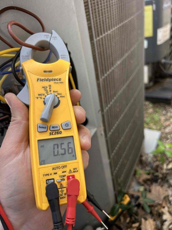 Completed comprehensive care plan tune-up on newly installed HVAC system consisting of two gas furnaces and one air conditioning unit with coil, all equipment located in attic. Performed diagnostic testing on outdoor condensing unit using clamp meter to verify proper electrical operation, measuring amperage draw at 0.56 amps. Inspected all equipment components, documented system conditions through photographs showing outdoor unit exterior with accumulated debris on protective grille, and confirmed all installations operating within normal parameters.