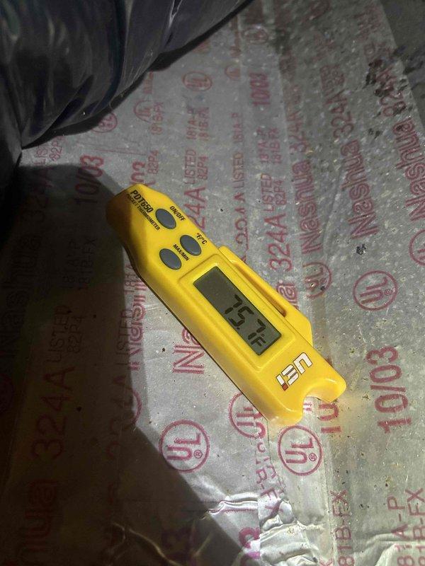 Responded to no-cooling complaint on upstairs air conditioning system. Upon arrival, found unit running continuously but failing to provide adequate cooling to conditioned space. Performed diagnostic temperature measurements at supply and return air locations. Supply air temperature measured 56°F at ductwork, while return air temperature measured 43.1°F at insulation board near air handler, indicating insufficient temperature split and compromised system performance. System exhibited short-cycling behavior with compressor turning on and off intermittently. Documented conditions with thermal readings for customer records and further evaluation of refrigerant charge, airflow restrictions, or potential compressor efficiency issues common in systems over ten years old.