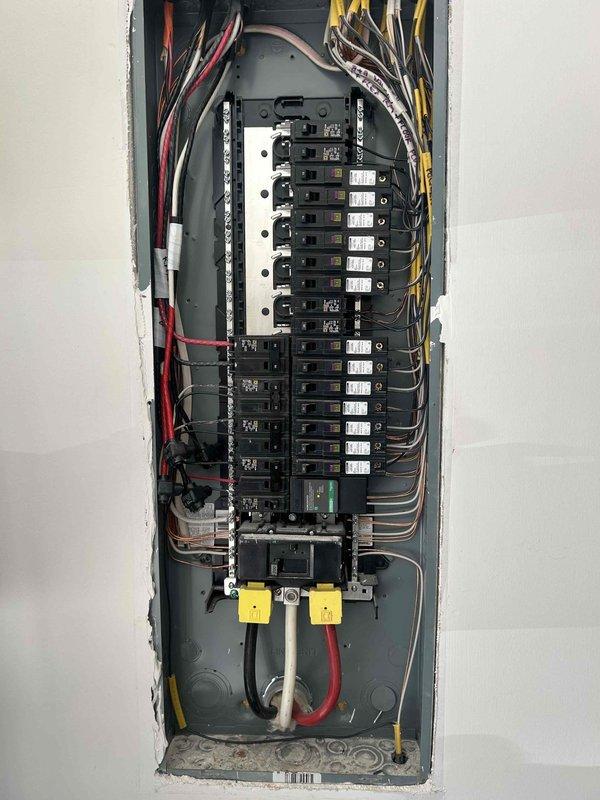 Conducted comprehensive electrical assessment for electric vehicle charging station installation in garage. Evaluated existing electrical panel capacity, available breaker spaces, and wire routing requirements from main panel to proposed charger location. Documented current panel configuration showing adequate 200-amp service with available spaces for dedicated EV circuit installation. Assessed wire run distance and determined optimal conduit pathway for Level 2 charging station installation. Provided detailed estimate for complete installation including 240-volt dedicated circuit, appropriate gauge wiring, conduit installation, and mounting of EV charging unit.