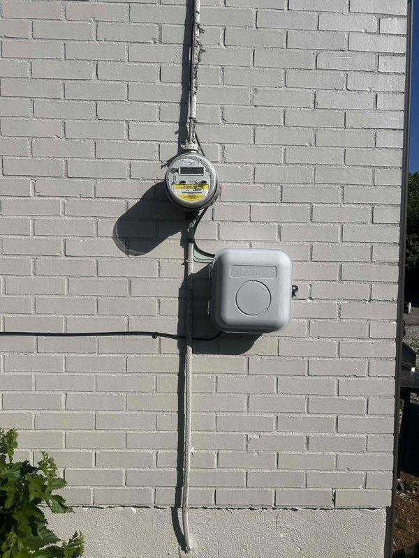 Upgraded electrical service from 60-amp to higher capacity for 1,750 square foot residence, including installation of new main service panel and meter base on exterior wall. Adjusted utility service drop from pole to meet current code height requirements. Installed dedicated 240-volt exterior disconnect and wiring for hot tub connection with appropriate GFCI protection and weatherproof enclosure.