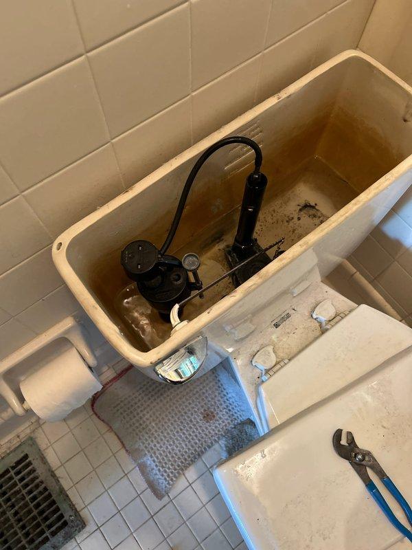 Responded to service call for toilet tank leak occurring at the flush handle assembly. Upon inspection, identified water leakage originating from the flush valve mechanism where the handle connects to the tank. Removed toilet tank lid and assessed internal components, noting deteriorated flush valve seal and worn mounting hardware at the handle connection point. The flush handle assembly showed signs of age-related wear, allowing water to bypass the seal during normal operation.

Replaced the defective flush valve assembly and handle mechanism with new components to eliminate the leak. Installed new tank-to-bowl mounting gasket and hardware as preventative measure. Tested flush operation multiple times to verify proper function and confirmed complete resolution of water leakage. All components now operating within manufacturer specifications with no visible water escape from tank or handle area.