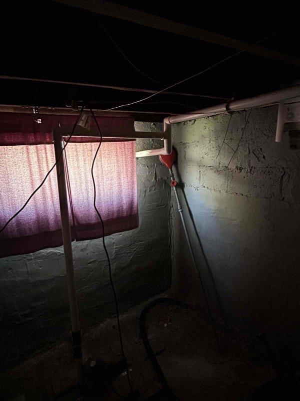 Successfully combined two basement sump pumps onto a single 2-inch discharge line, routing the piping across the basement with proper strapping and support under floor joists. The discharge line was run through the front right side of the foundation, with all wall penetrations properly sealed and patched. Approximately 20 feet of underground drainage line was installed in the front yard, terminating at a pop-up emitter for proper water dispersal. All connections were pressure-tested to confirm leak-free operation and proper drainage function before project completion.