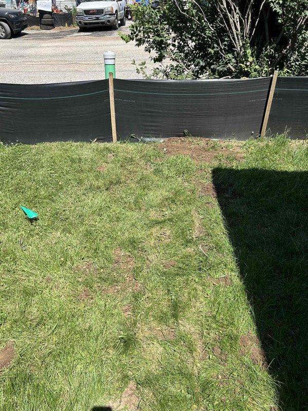 Successfully combined two basement sump pumps onto a single 2-inch discharge line, routing the piping across the basement with proper strapping and support under floor joists. The discharge line was run through the front right side of the foundation, with all wall penetrations properly sealed and patched. Approximately 20 feet of underground drainage line was installed in the front yard, terminating at a pop-up emitter for proper water dispersal. All connections were pressure-tested to confirm leak-free operation and proper drainage function before project completion.