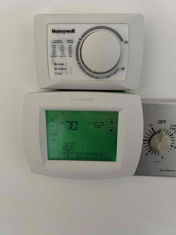 Completed Club Single preventive maintenance service on 15-year-old downstairs HVAC system. Performed comprehensive system inspection including electrical connections, control wiring, and thermostat operation. Verified proper function of Honeywell digital programmable thermostat displaying 73°F current temperature with 62°F setpoint in Permanent Hold mode. Inspected control panel wiring connections and terminal strips for secure contact and proper voltage. Documented equipment condition through photographic records. System operating within normal parameters upon completion of maintenance visit.
