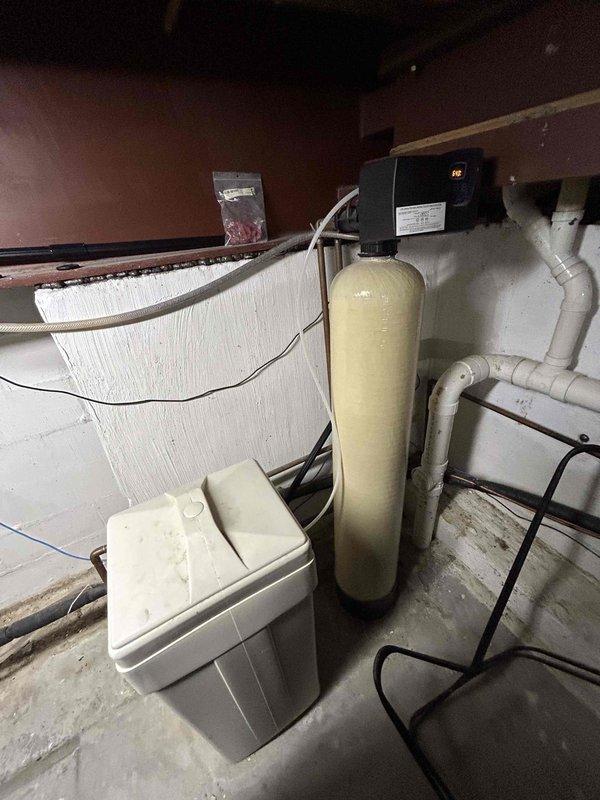 Conducted water treatment estimate for replacement of existing water softening system. Evaluated current installation in basement utility area, which included aging water softener tank, brine tank, and associated plumbing connections. Assessed customer requirements for GE brand filtration and softening system to replace current equipment. Documented existing system configuration, PVC piping layout, electrical connections, and available space for new installation. Provided recommendations for complete water softening system replacement with options for financing consideration.