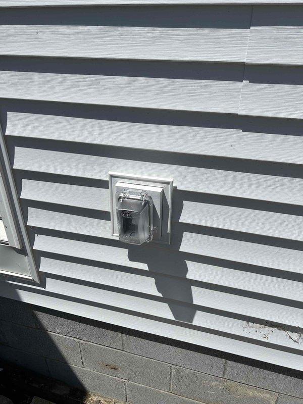 Completed final phase of electrical rewire installation including mounting of all devices, fixtures, and cover plates throughout the property. Installed exterior electrical meter enclosure on building exterior wall and mounted dual-head security lighting fixture under soffit overhang with proper weatherproof connections. All work completed to code specifications and prepared for final electrical inspection.