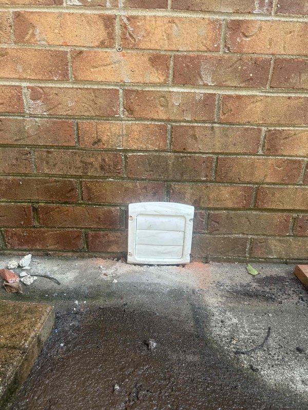 Performed complete dryer vent cleaning service, removing significant accumulation of lint buildup from the exhaust system. Extracted large volume of compacted lint material that had created a blockage hazard, improving airflow and reducing fire risk. Installed new white plastic louvered vent cap with secure mounting to replace the existing deteriorated cover, ensuring proper exterior termination and protection against weather intrusion and pest entry.