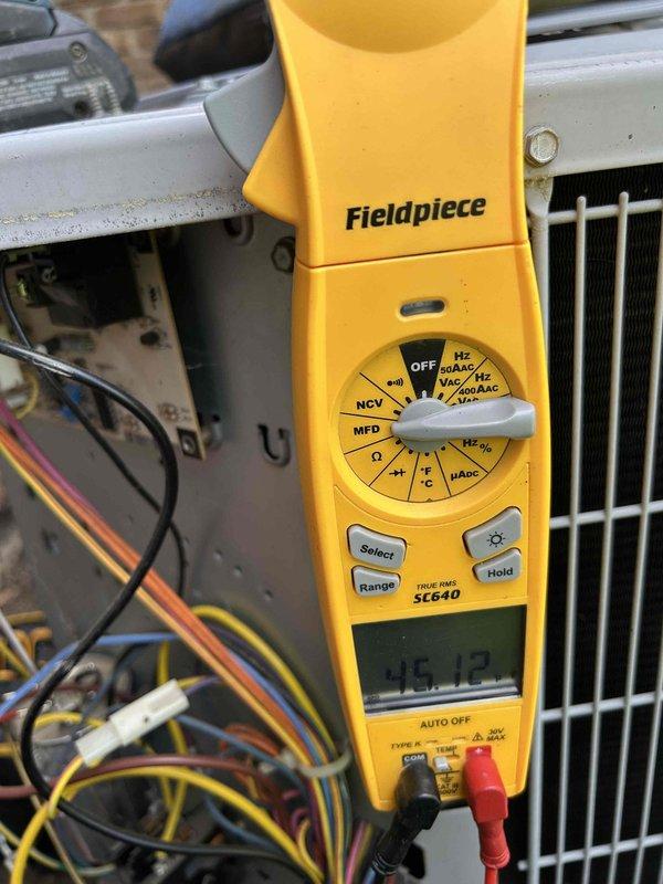 Completed preventive maintenance tune-up on heat pump and air handler system located in attic space. Performed comprehensive system diagnostics including electrical testing with capacitance readings showing 45.12 MFD on measured component. Inspected evaporator coil assembly and identified significant rust and corrosion present along coil frame seams and lower panel edges, with left side showing more extensive deterioration than right side. Coil fins remain intact and functional despite frame corrosion. Documented system condition with photos for service records. Customer providing their own filters for unit.