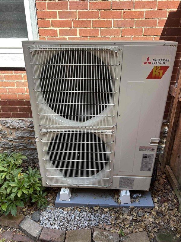 Completed annual care plan maintenance tune-up on Carrier heat pump system with air handler located in basement. Performed comprehensive inspection of indoor and outdoor equipment, verified thermostat operation showing 69°F actual temperature, inspected Mitsubishi Electric outdoor unit with dual fan configuration, checked electrical connections, tested system controls, and confirmed proper operation of all components. Customer provides their own 20x25x4 filter for routine replacement.