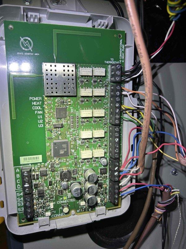 Responded to service call for HVAC system producing unusual noise and insufficient cooling with thermostat set to 70°F. Performed diagnostic inspection of outdoor condenser unit and indoor control board. Examined compressor operation, refrigerant line connections, and electrical components including PCB with integrated circuits and terminal connections. Identified operational issues affecting system performance and cooling capacity. Documented equipment condition with photographs of outdoor unit installation and control board wiring configuration for service records.