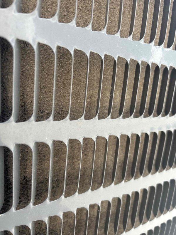 Responded to no cooling complaint on 2-year-old electric HVAC system experiencing issues for several weeks. Upon inspection, found evaporator coil heavily contaminated with dust and debris buildup restricting airflow. Connected Fieldpiece digital manifold gauges and verified R410A refrigerant system operating with abnormally low suction pressure at 40.0 psi, resulting in vapor saturation temperature of -6.7°F, indicating insufficient heat absorption due to reduced airflow across coil. Documented dirty coil condition and explained that accumulated debris between fins was preventing proper heat exchange and causing system to fail to cool adequately.