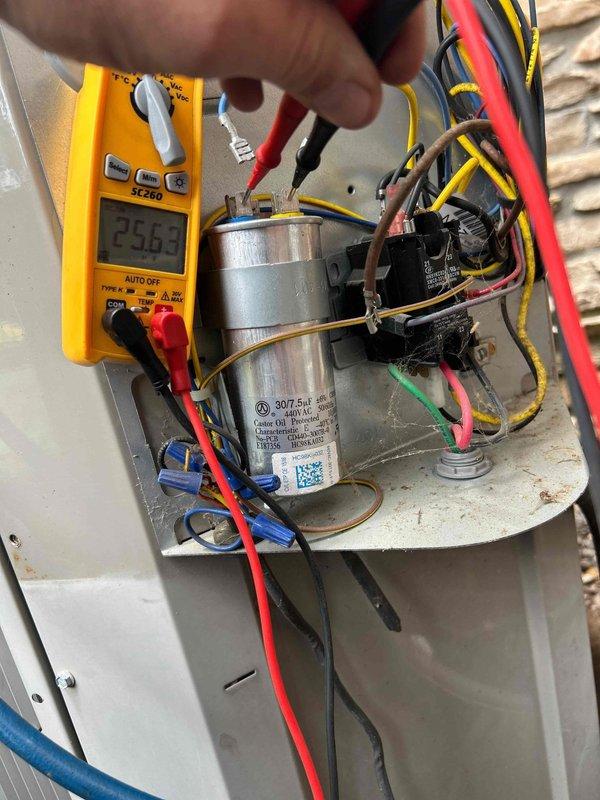 Performed comprehensive preventive maintenance tune-up on heat pump system with air handler located in attic and heat pump ground unit in basement as part of recurring care plan service. Conducted thorough electrical diagnostics on outdoor unit, including capacitor testing with digital multimeter, which confirmed dual-run capacitor reading of 25.62μf within acceptable tolerance range for the 30/7.5μf rated component. Inspected all electrical connections, contactors, and relay components for proper operation and secure terminations. Verified all wire connections including power, control, and ground circuits were tight and properly bundled. Evaluated overall system performance and confirmed equipment operating within normal parameters.