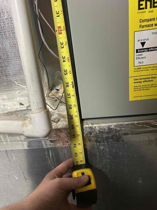 Responded to no cooling call on electric HVAC system that had been non-operational for several days. Upon arrival, found Carrier programmable thermostat displaying 73°F in heat mode rather than cooling mode. Performed system diagnostics on basement-located furnace and associated cooling components. Documented equipment specifications and clearances, noting 80.0 AFUE gas furnace with standard PVC condensate drainage. Filter had not been changed since January, which may have contributed to airflow restrictions. Assessed thermostat programming and system operation to determine root cause of cooling failure and restore proper functionality to the aging system.