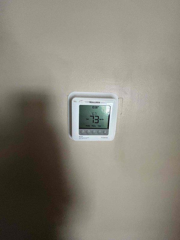 Completed routine HVAC maintenance on heat pump system with air handler located in attic. Verified thermostat operation showing proper temperature reading of 73 degrees with system responding appropriately to programmed settings. Performed diagnostic testing on outdoor condensing unit using calibrated manifold gauges to measure system pressures and temperatures, confirming refrigerant charge and overall system performance within manufacturer specifications. Customer provides their own air filtration for the attic-mounted air handler unit.