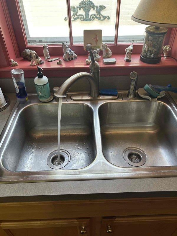 Completed comprehensive 60-point plumbing inspection of residential property and performed tanked water heater flush service. Inspection included evaluation of all accessible plumbing fixtures, supply lines, drain systems, and shut-off valves throughout the home. Examined bathroom sink with wall-mount installation, verified proper operation of chrome fixtures and cross-handle faucet controls, and inspected visible water supply lines for leaks or corrosion. Assessed kitchen double-basin stainless steel sink with single-handle faucet, checked under-sink plumbing connections and cabinet areas for moisture or damage. Flushed tanked water heater to remove sediment buildup and maintain optimal heating efficiency and equipment longevity. All systems found operating within normal parameters with no immediate repairs required.