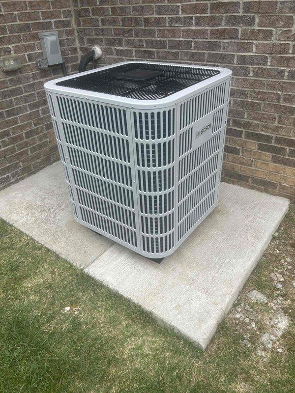 Completed full residential HVAC system installation including Bosch heat pump model BOVA60RTBM20, Bosch air handler model BIVA48RCBM20 with 15KW heat kit (L83-049), and Bosch communicating thermostat (L51-915). Relocated air handler to the left and installed new base box with built-in 1" filter rack to improve accessibility and filtration. Removed existing barrier in main return wall opening to enhance airflow into air handler and eliminate whistling noise caused by restricted return air passage.

Installed outdoor unit on concrete pad with snow legs for elevation and drainage, complete with electrical whip kit and disconnect box. Added surge protection and insulated refrigerant lines with inline filter for system protection. Mounted air handler in interior utility closet with proper transitions to existing ductwork. Installed comprehensive drain safety system including trap, SS2 coil drain safety water sensor, and "Ceiling Saver" overflow drain pan with secondary water sensor for leak