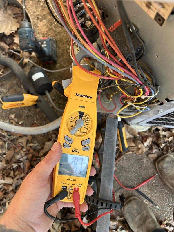 Completed routine maintenance tune-up on 1-ton heat pump system with gas furnace backup as part of annual care plan service. Accessed equipment in tight crawlspace conditions, performed comprehensive electrical diagnostics using Fieldpiece SC640 meter with readings of 107.3V and 689Ω recorded on outdoor condensing unit components, verified capacitor function, inspected all wiring connections and terminals, and installed new 16x25x1 air filter per plan specifications.