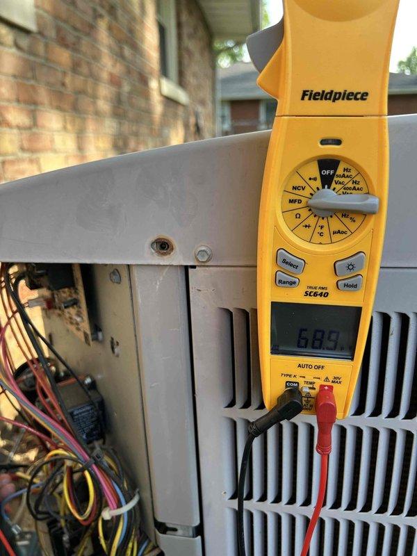 Completed routine maintenance tune-up on 1-ton heat pump system with gas furnace backup as part of annual care plan service. Accessed equipment in tight crawlspace conditions, performed comprehensive electrical diagnostics using Fieldpiece SC640 meter with readings of 107.3V and 689Ω recorded on outdoor condensing unit components, verified capacitor function, inspected all wiring connections and terminals, and installed new 16x25x1 air filter per plan specifications.