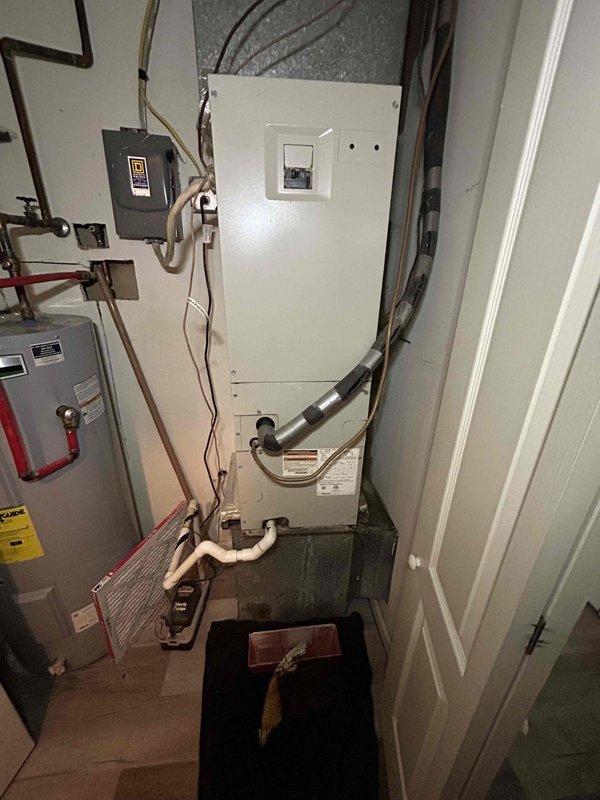 Responded to no cooling complaint on gas furnace system over 10 years old at rental property. Arrived on site before noon as requested and contacted tenant for access to hallway closet indoor unit location. Performed diagnostic evaluation of complete HVAC system including indoor air handler and outdoor condensing unit. Inspected refrigerant lines, electrical connections, and condenser unit exterior installation. Evaluated air handler cabinet, associated ductwork, and electrical panel connections in mechanical closet. Documented system conditions with photographs showing outdoor unit installation area and indoor equipment configuration. Communicated findings and recommended repairs to property owner prior to proceeding with any corrective work per rental property protocol.