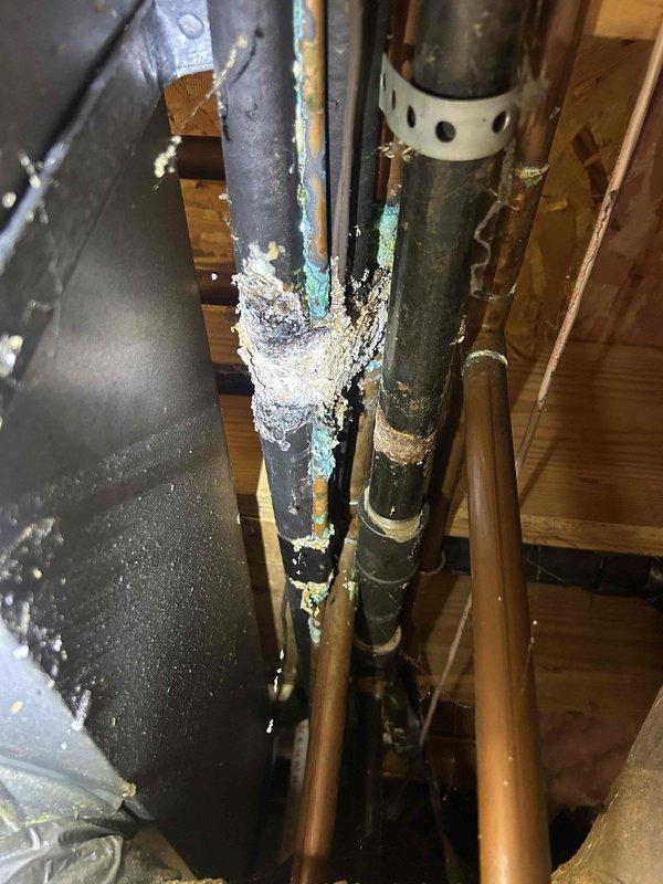 Responded to non-urgent service call to assess HVAC line interference with plumbing repair work. Upon inspection of attic space, documented existing refrigerant line set routing that requires relocation to allow plumbing contractor access for water line leak repair. Photographed current piping configuration showing copper refrigerant lines, support brackets, and proximity to affected plumbing area. Noted significant frost accumulation on copper refrigerant line indicating active system operation and proper refrigerant flow. Documented spatial constraints including wooden structural beams, existing ductwork, and insulation that will impact line set relocation. Prepared documentation and photographs for quote preparation to relocate refrigerant line set, which will require system pump-down, line disconnection, rerouting, reconnection, pressure testing, evacuation, and refrigerant recharge upon completion.