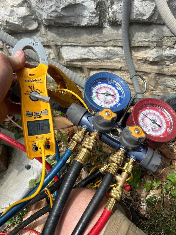 Responded to no cooling complaint on 17-year-old upstairs heat pump system with indoor unit located in attic. Performed diagnostic testing using manifold gauges and clamp meter to measure refrigerant pressures and electrical current at outdoor unit. Testing revealed system operating parameters were outside normal range, indicating potential refrigerant charge issue or compressor performance problem requiring further evaluation and repair.