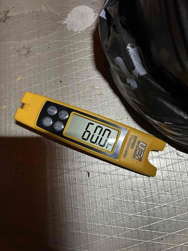 Responded to no cooling complaint on 4-year-old heat pump system with attic-mounted air handler displaying thermostat error code. Upon inspection, discovered severely frozen evaporator coil with heavy ice accumulation across entire coil surface. Measured supply air temperature at 45°F and superheat at 6°F, confirming restricted airflow condition causing coil to ice over and preventing proper heat exchange. Diagnostic findings indicate inadequate airflow due to either dirty coil, blower motor failure, or refrigerant system issue requiring further evaluation after coil defrost.